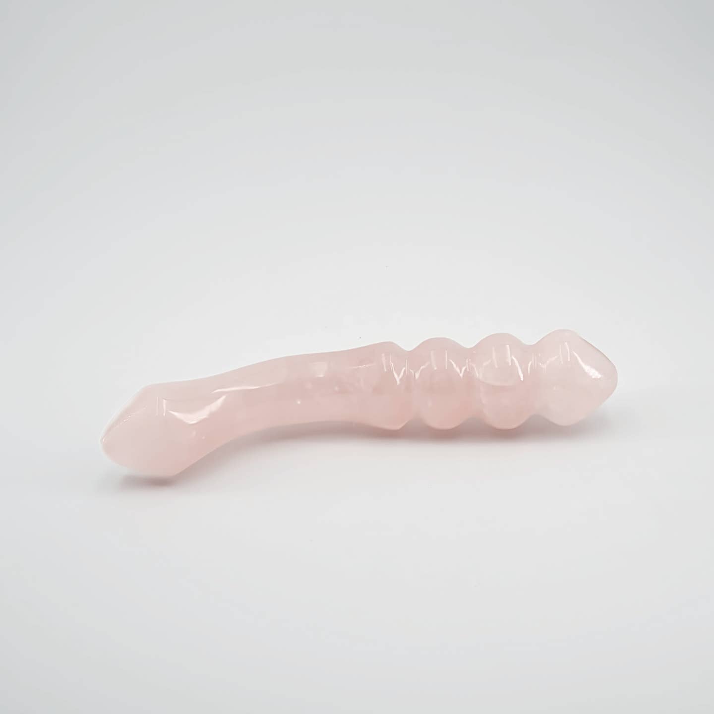 Curvona natural rose quartz crystal wand for meditation, wellness, chakra balancing, relaxation, and energy work.