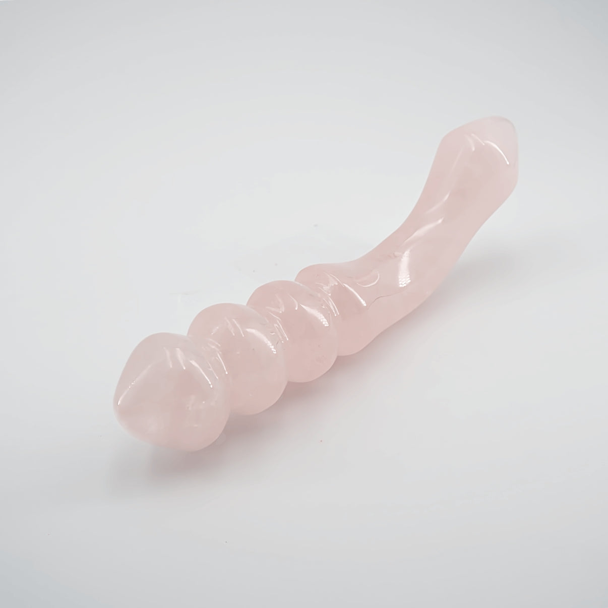 Curvona natural rose quartz crystal wand for meditation, wellness, chakra balancing, relaxation, and energy work.