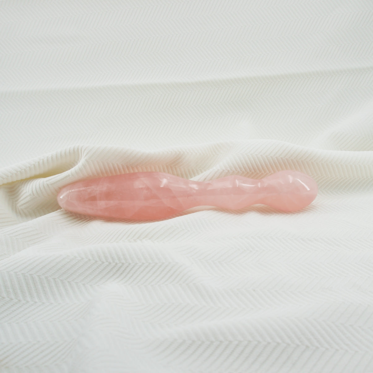 Ellure handcrafted rose quartz crystal wellness wand made from natural rose quartz for meditation, mindfulness, relaxation, energy work, chakra balancing, and luxury self-care rituals.