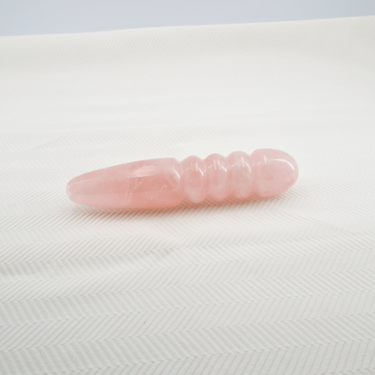 Unduluna handcrafted rose quartz crystal wand made from natural rose quartz for meditation, mindfulness, energy work, chakra balancing, relaxation, and luxury self-care rituals.