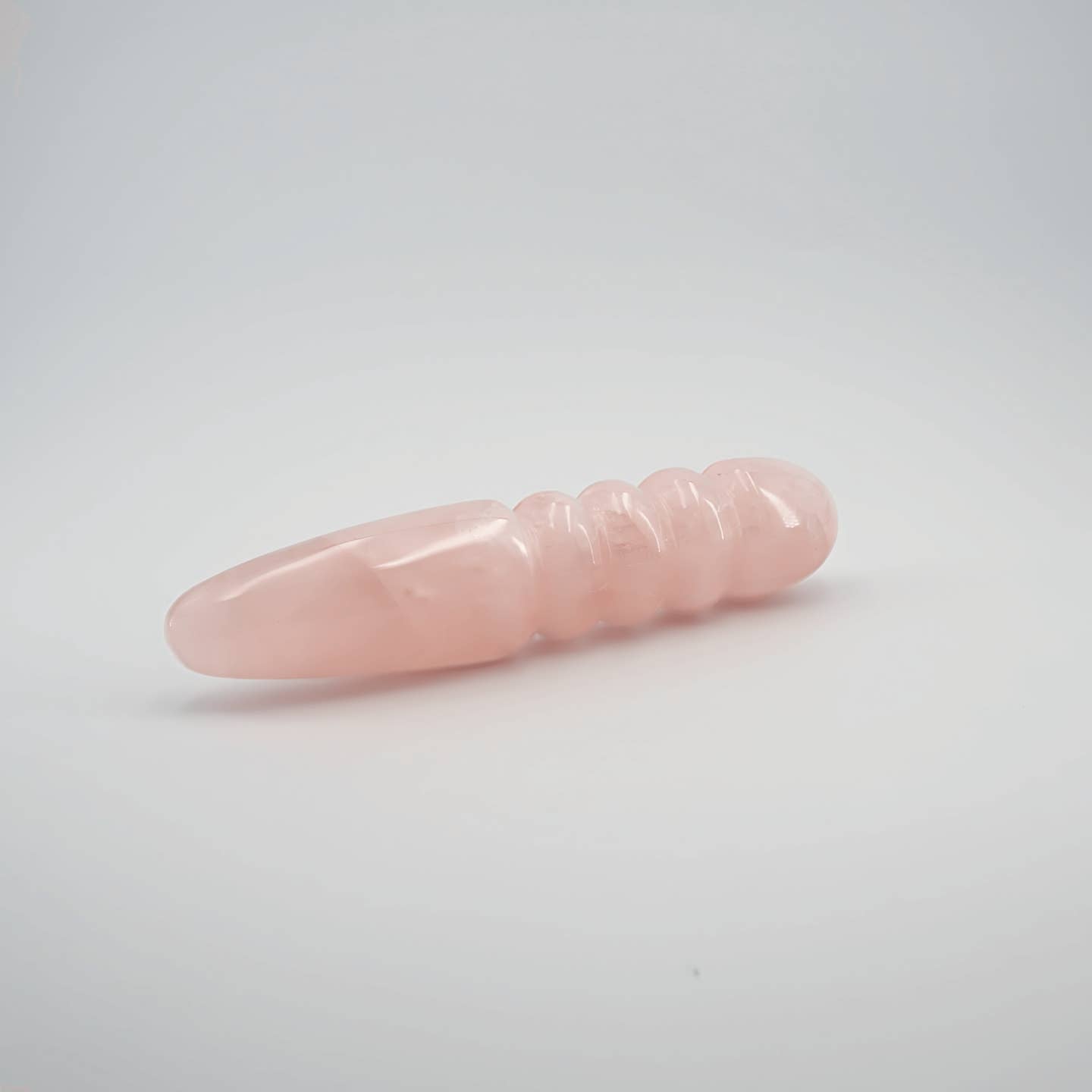 Unduluna handcrafted rose quartz crystal wand made from natural rose quartz for meditation, mindfulness, energy work, chakra balancing, relaxation, and luxury self-care rituals.