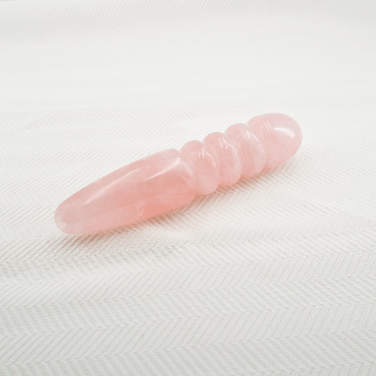 Unduluna handcrafted rose quartz crystal wand made from natural rose quartz for meditation, mindfulness, energy work, chakra balancing, relaxation, and luxury self-care rituals.